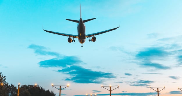 airplane-silhouette-landing-airport-dusk_108072-1329