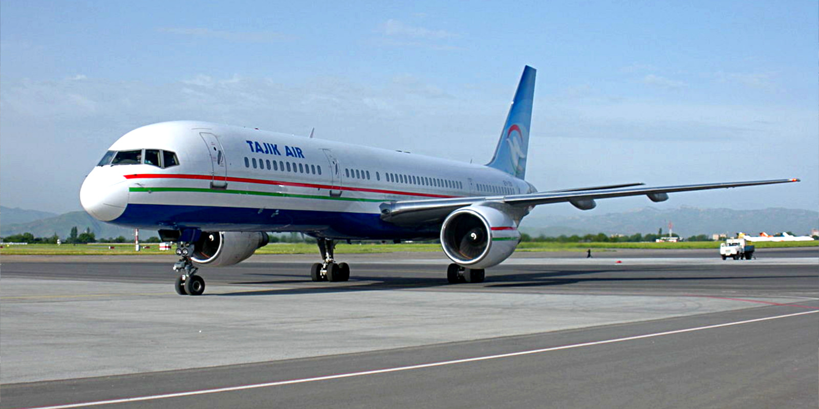 A Tajik Air airliner at rest on the tarmac.